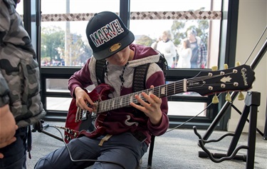 Young person playing guitar in the Recording Studio